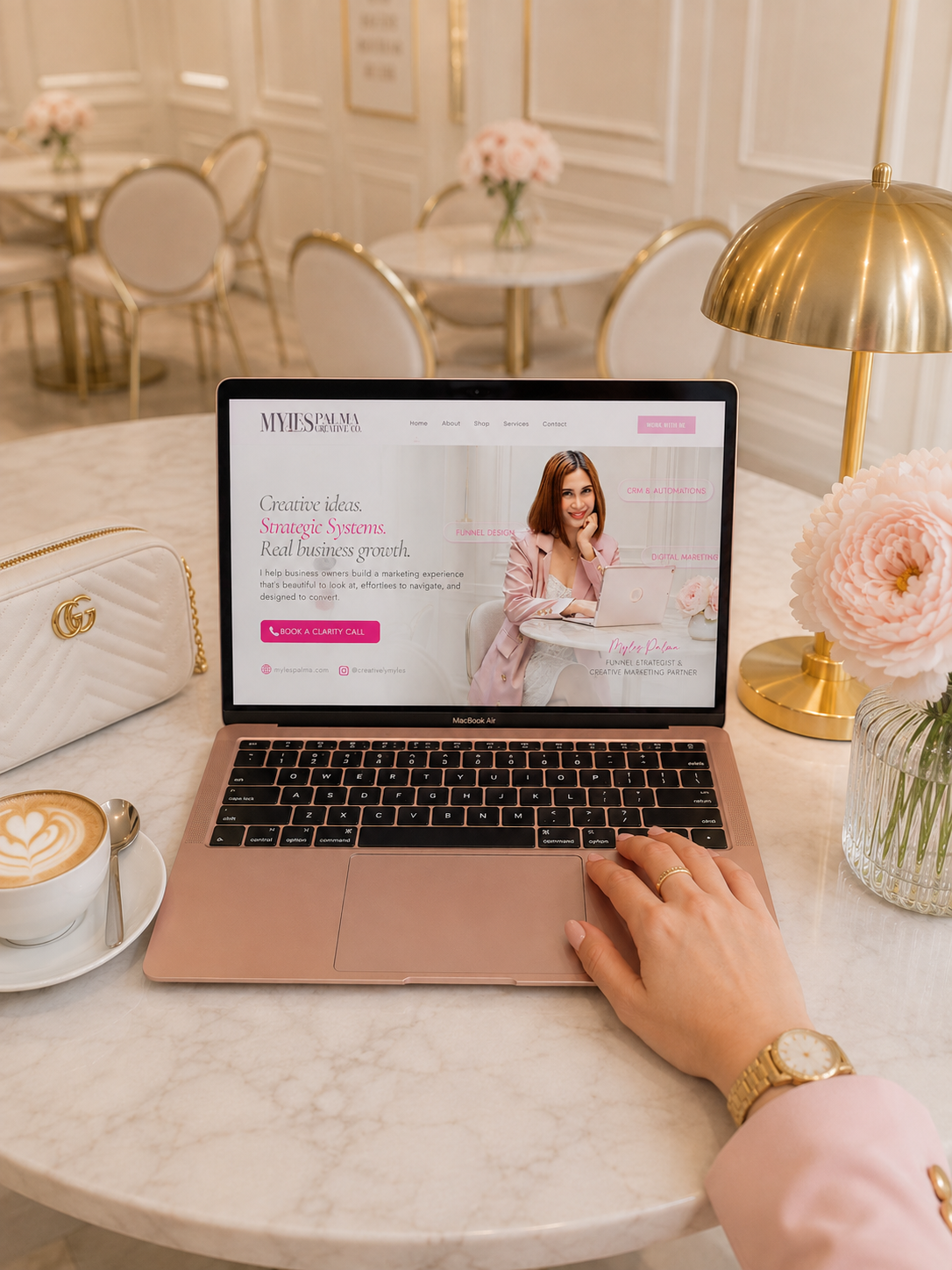 Myles Palma's website open on a laptop in a Parisian café
